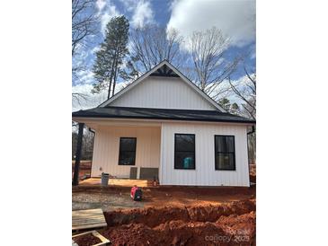 Charming white home featuring black trim, windows, and a newly installed roof at 625 Academy St, Cleveland, NC 27013