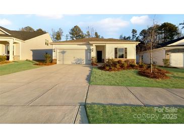 Charming single-story home with a well-maintained lawn and attached garage, creating a welcoming curb appeal at 9819 Festival Way, Charlotte, NC 28215