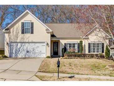 Charming single Gathering home featuring a two-car garage, and well-manicured lawn at 10390 Tintinhull Dr, Indian Land, SC 29707