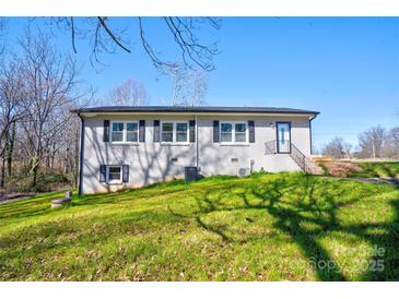 Traditional brick home with manicured lawn, dark shutters, and a side entry with stairs leading to the front door at 108 Spiral Ln, Shelby, NC 28152