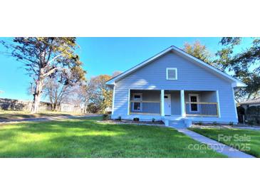 Charming single-story home featuring a covered front porch, fresh lawn, and inviting curb appeal at 155 31St Sw St, Hickory, NC 28602