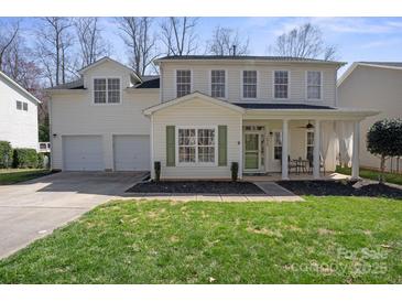 Charming two-story home with a well-manicured lawn, attached two car garage and inviting front porch at 18948 Kanawha Dr, Cornelius, NC 28031