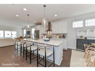 Bright open kitchen featuring a large island with pendant lighting and modern appliances at 208 Wesser St # 8, Davidson, NC 28036