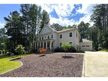 Charming two-story home with a covered front porch and a well-manicured lawn at 220 Kenway Loop, Mooresville, NC 28117