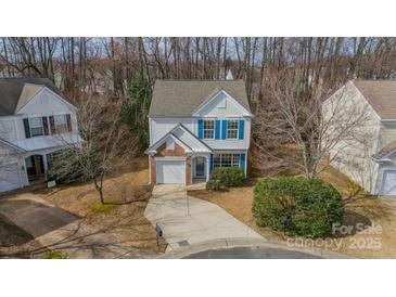 Charming two-story home featuring a brick accent garage and beautiful blue shutters at 3554 Laurenhurst Ln, Charlotte, NC 28270