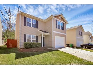 Charming two-story home featuring neutral siding, black shutters, well-manicured lawn, and an attached one-car garage at 5830 Kelden Walker Ln, Charlotte, NC 28269