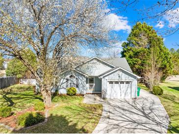 Charming single-Gathering home featuring a well-manicured lawn and a blossoming tree in a suburban neighborhood at 6325 Martin Lake Rd, Charlotte, NC 28227