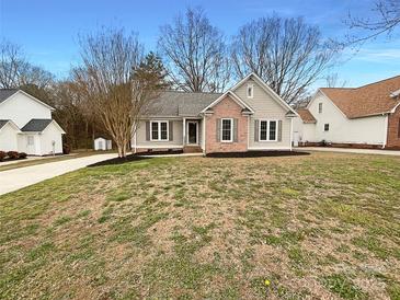 Charming brick and siding home with a manicured front yard and mature trees at 1971 Bristol Pkwy, Rock Hill, SC 29732