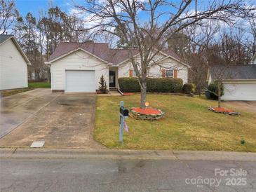 Charming single-story home with a well-manicured lawn, inviting curb appeal, and an attached one-car garage at 8808 Shady Pine Ct, Charlotte, NC 28214