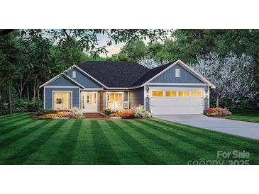 Charming single-story home featuring a two-car garage, well-manicured lawn and tastefully landscaped flower beds at 125 Camille Dr, Shelby, NC 28150