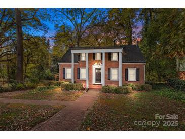 Charming brick home with black shutters, a columned portico and walkway at 14725 N Old Statesville Rd, Huntersville, NC 28078
