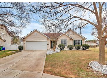 Inviting single-story home featuring a two-car garage and a well-maintained lawn at 15707 Southern Garden Ln, Charlotte, NC 28278