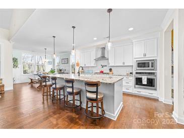 Bright kitchen features a large center island with bar seating and modern stainless steel appliances at 158 Country Lake Dr, Mooresville, NC 28115