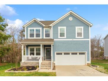 Charming two-story home showcasing blue siding, stone accents, and a welcoming front porch at 18607 Mainsail Ct, Lancaster, SC 29720