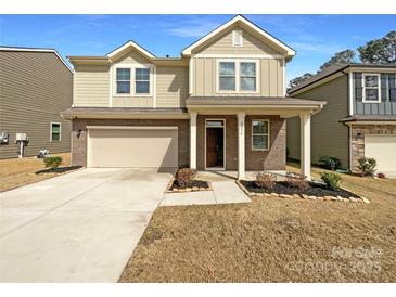 Charming two-story home featuring a brick facade, covered porch, and a well-maintained front yard at 2236 Sussex Rd, York, SC 29745