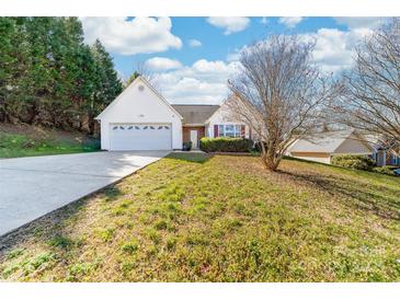 Charming home featuring an attached two-car garage, white siding, and a well-maintained front yard with lush greenery at 2359 Eagle Glen Ct, Gastonia, NC 28056