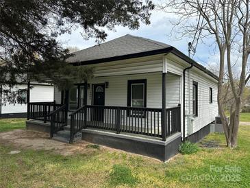 Charming one-story home featuring a covered front porch with black railings and fresh landscaping at 3342 York Hwy, Gastonia, NC 28052