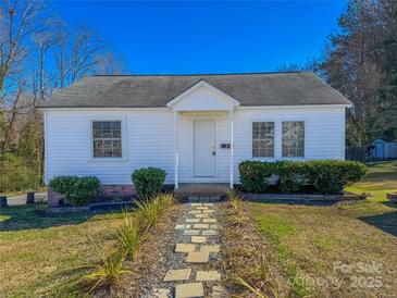 Charming single-story home with white siding, walkway, and landscaped front yard under a clear blue sky at 826 E Alexander St, Lincolnton, NC 28092