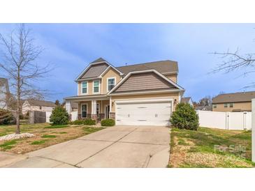 Inviting two-story home with a two car garage, well-maintained lawn, and a welcoming porch at 10605 Three Rivers Ct, Charlotte, NC 28273