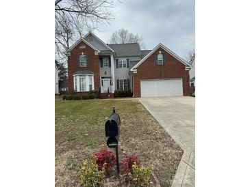 Charming two-story brick home with a well-manicured lawn and a two-car garage at 10607 Old Bridge Ln, Charlotte, NC 28269