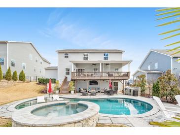 Inviting backyard showcases a pool, spa, deck with an outdoor living area and grill at 14130 Sunnyhill Grove Rd, Davidson, NC 28036