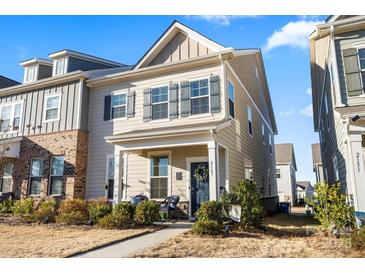 Charming two-story home with gray shutters, covered front porch, and lush landscaping at 2147 Stevens Mill Rd, Matthews, NC 28104