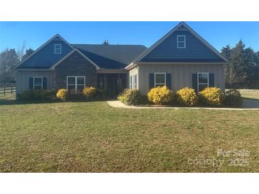 Charming single-story home featuring stone accents, blue shutters, and a well-maintained lawn at 255 Dorothy Dr, China Grove, NC 28023