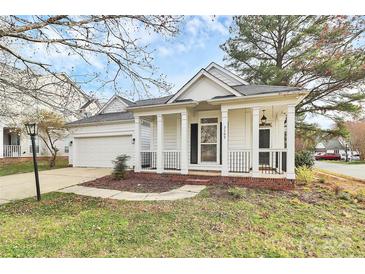 Charming one-story home featuring a covered front porch with classic white columns and manicured landscaping at 2702 Robyns Glen Dr, Charlotte, NC 28269