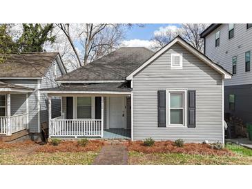 Charming home featuring a covered porch and gray siding at 312 Flint St, Charlotte, NC 28216