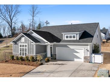 Charming single-Gathering home featuring stone accents, a two-car garage, and a well-manicured front yard at 5367 Heartwood Ln, Denver, NC 28037