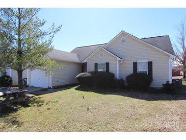 Charming single-story home featuring a manicured lawn and attached garage at 5809 Carolina Manor Ct, Indian Trail, NC 28079