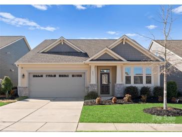 Charming single-Gathering home with a well-manicured lawn and attached two-car garage at 809 Cadence Park Pl, Fort Mill, SC 29708