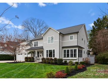 Stunning two-story home with a manicured lawn, charming landscaping and a white picket fence at 846 Wriston Pl, Charlotte, NC 28209