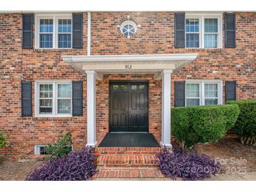 Charming brick home featuring a classic front entrance with black shutters and a well-manicured lawn at 912 Mcalway Rd # D, Charlotte, NC 28211