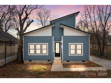 Charming blue home boasting a modern design and a welcoming entrance with black trim windows, enhancing curb appeal at 913 Wilson W Lee Blvd, Statesville, NC 28677