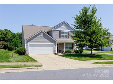 Charming two-story home with a well-manicured front lawn and attached two-car garage at 137 Mossy Pond Rd, Statesville, NC 28677