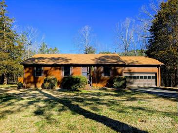 Charming ranch-style home with a well-maintained lawn and an attached garage at 1376 Devinney Rd, York, SC 29745