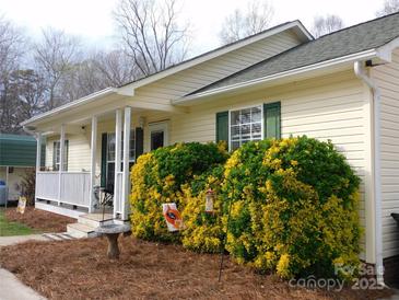 Inviting single-story home featuring a charming porch and well-maintained landscaping at 14440 W Highway 55 Hwy, Blacksburg, SC 29702