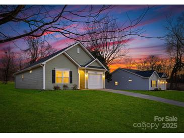 Charming single-Gathering home showcasing a well-maintained lawn and an inviting two-car garage at 1505 W May Ave, Gastonia, NC 28052