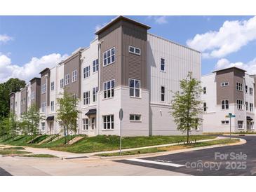 Modern townhome exterior showcasing neutral tones, brick accents, and well-manicured landscaping at 5007 Nimes Rd # 28, Charlotte, NC 28208