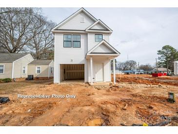 New construction home featuring white siding, a garage, and a covered front entrance at 504 Sharpe St, Mooresville, NC 28115