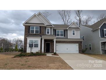 Charming two-story home with a two-car garage and brick and gray siding at 14705 Superior St, Charlotte, NC 28273