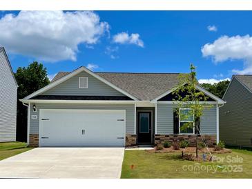 Charming single-story home featuring a two-car garage, light gray siding, and stone accents on the facade at 1568 Doran Ter, Richburg, SC 29729