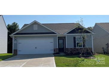 Charming single-story home featuring a two-car garage, stone accents, and well-manicured lawn at 1568 Doran Ter, Richburg, SC 29729