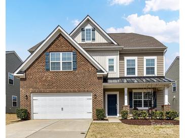 Charming two-story home with brick and vinyl siding, a well-maintained lawn, and an attached two-car garage at 15954 Harbor Hill Dr, Charlotte, NC 28273