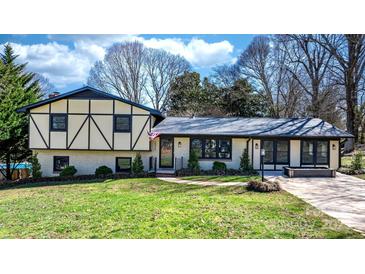 Beautiful home with a well-manicured lawn, a combination of brick and stucco, and a blue sky backdrop at 2530 31St Street Ne Dr, Hickory, NC 28601