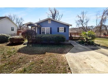 Charming blue home featuring a landscaped front yard, sidewalk and a wooden deck on the side at 2725 Fair Oaks Dr, Gastonia, NC 28054