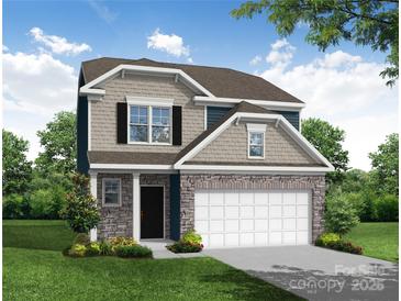 Charming two-story home featuring stone accents, a two-car garage, and a beautifully landscaped front yard at 2809 Ashton Park Ln # 72, Monroe, NC 28110