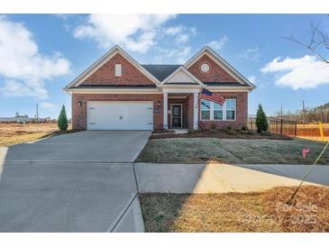 Charming single-story brick home with a two-car garage and manicured lawn at 3069 Founding Fathers Dr, Gastonia, NC 28056