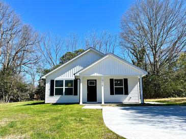 Charming one-story home with a well-maintained lawn and black window shutters at 324 Ashford St, Chester, SC 29706